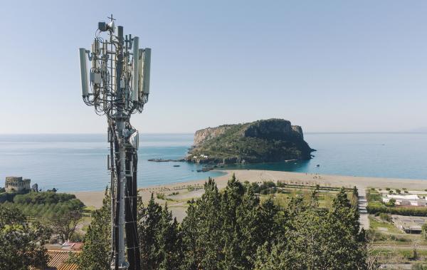 Trinity Gate Investments Interview with INWIT, cell phone tower on the beach facing an islet