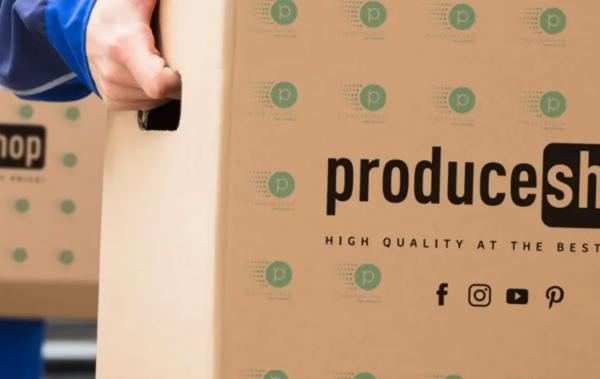 Trinity Gate Investments interview with ProduceShop, delivery man holding a Produceshop box